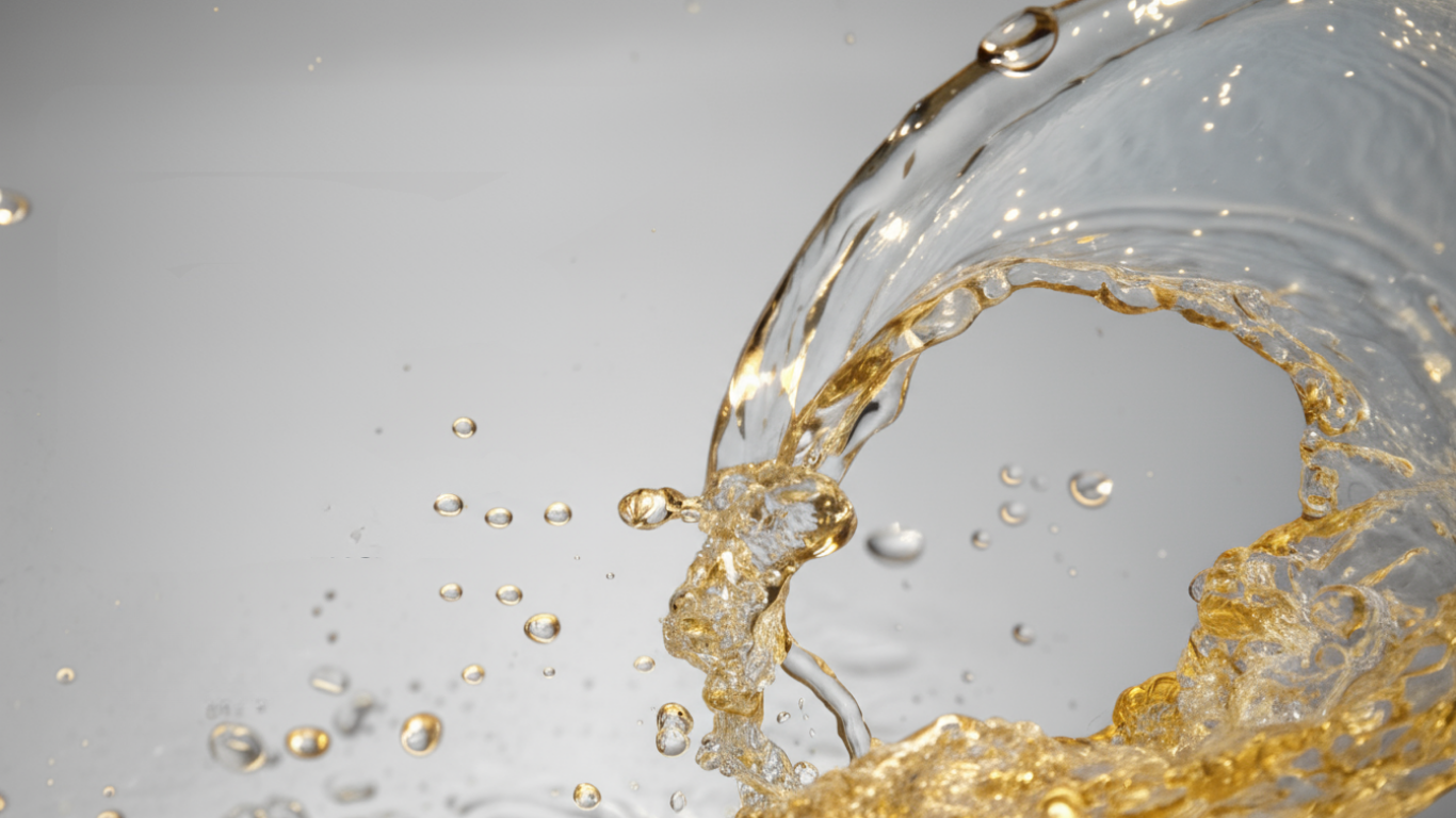 Gold liquid splashing against a gray background