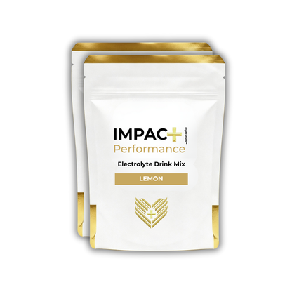 2 IMPAC+ Performance electrolyte drink mix packages with lemon flavor on a white background
