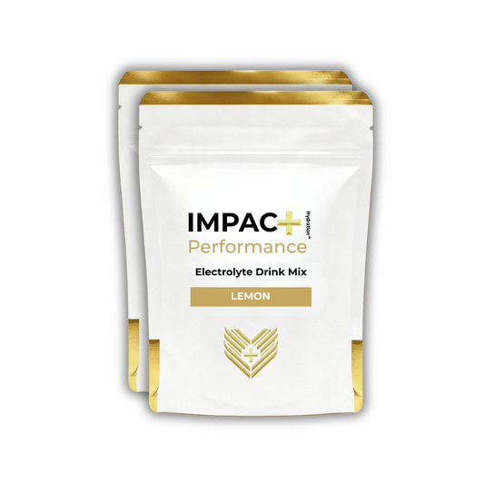 2 IMPAC+ Performance electrolyte drink mix packages with lemon flavor on a white background